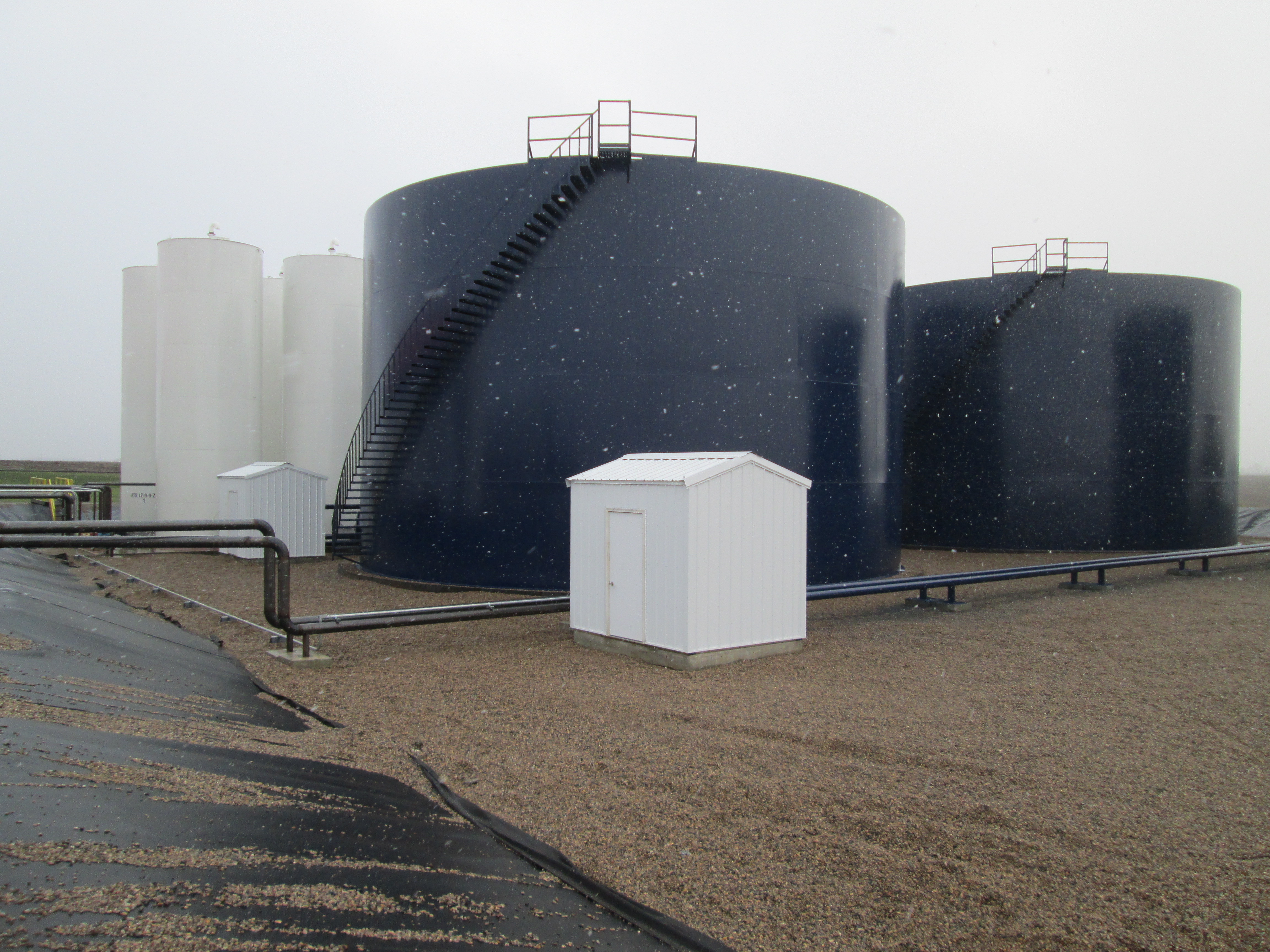 Photo shows field erected and manufactured fertilizer tanks located in an outdoor fertilizer containment dike. 