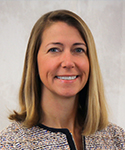 woman with long blond hair wearing a suit