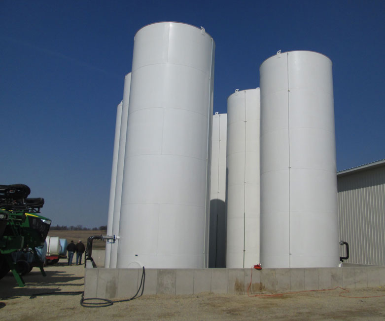 Photo shows mild steel manufactured bulk liquid fertilizer tanks in an outdoor fertilizer containment dike. 