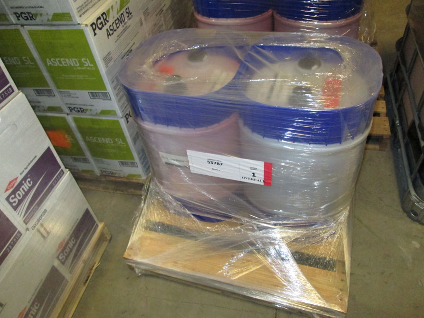 Photo shows small package pesticides on pallets. 