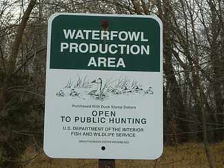 Green and white Waterfowl Production Area sign