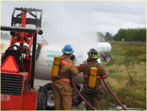 Firefighters near and anhydrous ammonia tank that is leaking.