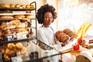 Happy bakery owner in business shop