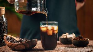 person pouring cold brew coffee