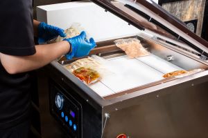 food employee conducting reduced oxygen packaging of products