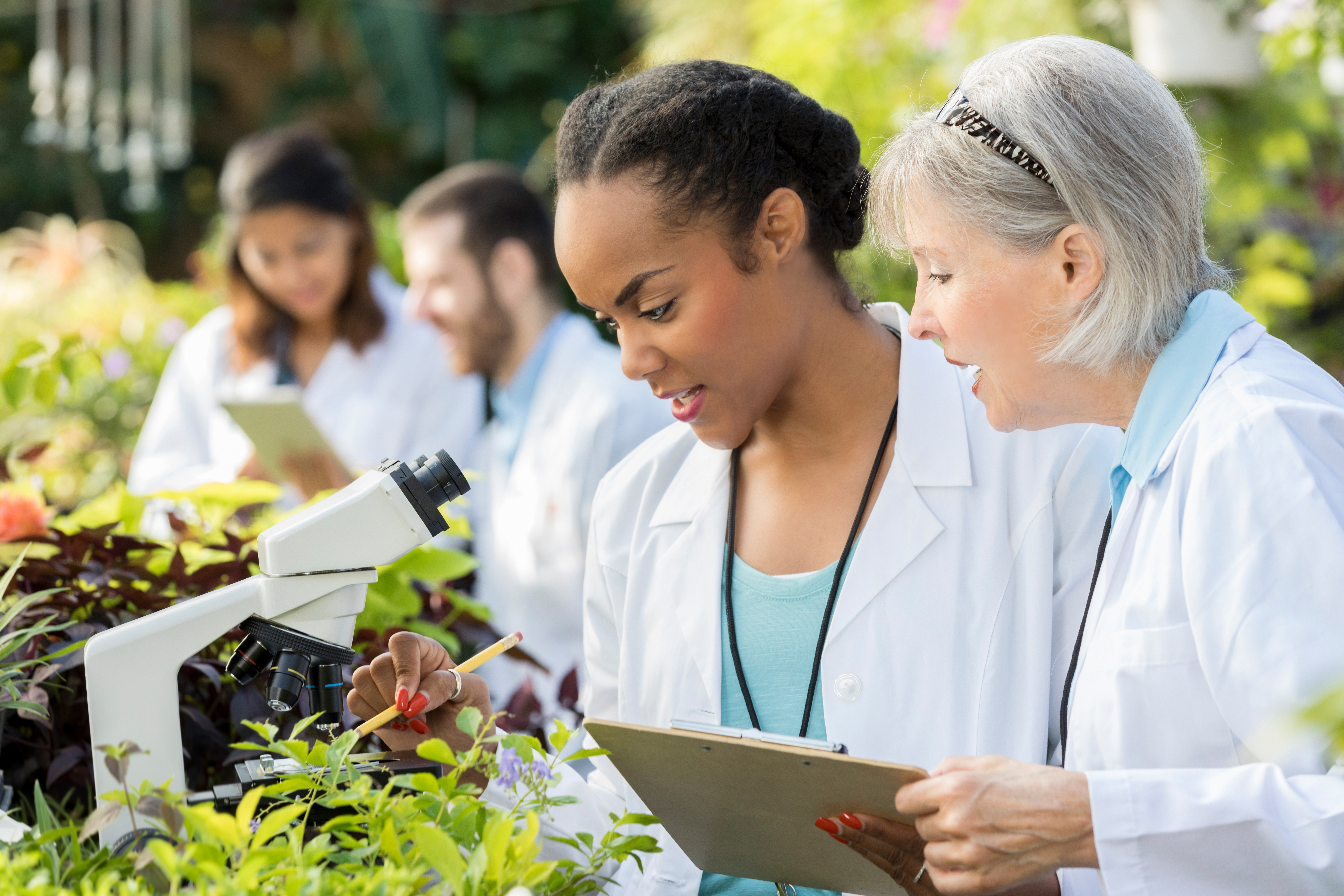 senior botanist mentoring a younger botanist