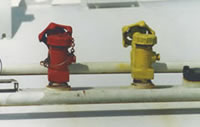 Two valves next to each other, painted different colors. One red, one yellow.