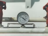 Pressure gauge mounted to a tank.