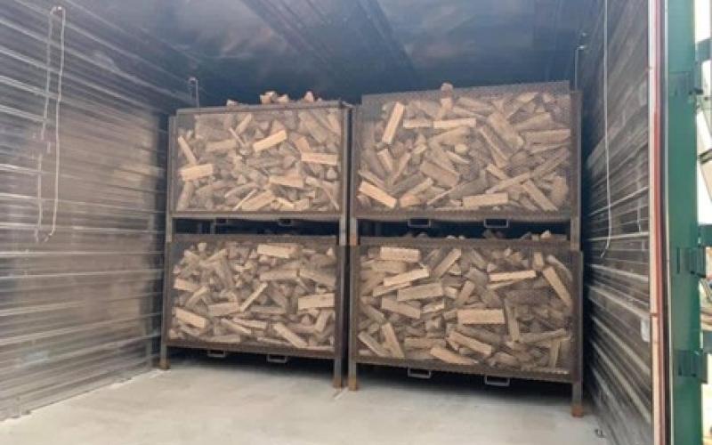 four large containers filled with firewood