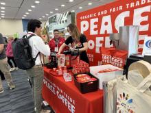 Attendee getting a sample beverage from two vendors